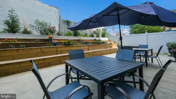 an outdoor space with furniture and umbrella