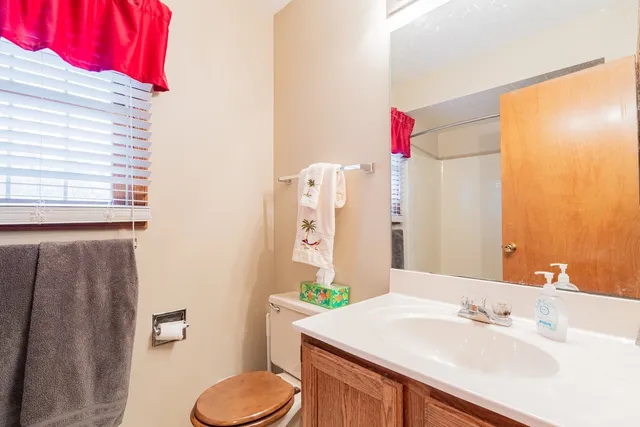 a view of a room with windows and a ceiling fan