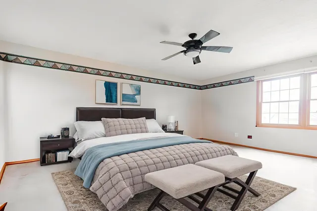 a bedroom with a bed and a chandelier