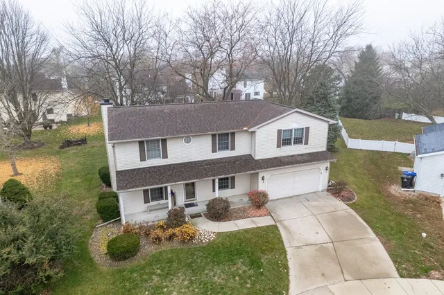 a aerial view of a house with yard porch and furniture