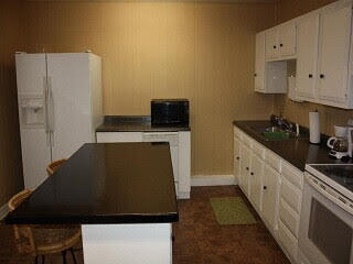 2123 25th Street Lubbock, TX 79411 - Photo 3 of 12 a kitchen with a sink and a refrigerator