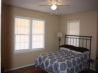 2123 25th Street Lubbock, TX 79411 - Photo 4 of 12 a bedroom with a bed and window