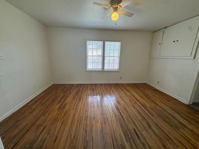 2123 25th Street Lubbock, TX 79411 - Photo 7 of 12 wooden floor in an empty room with a window