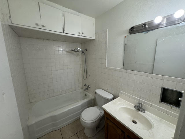 2123 25th Street Lubbock, TX 79411 - Photo 8 of 12 a bathroom with a sink toilet and shower