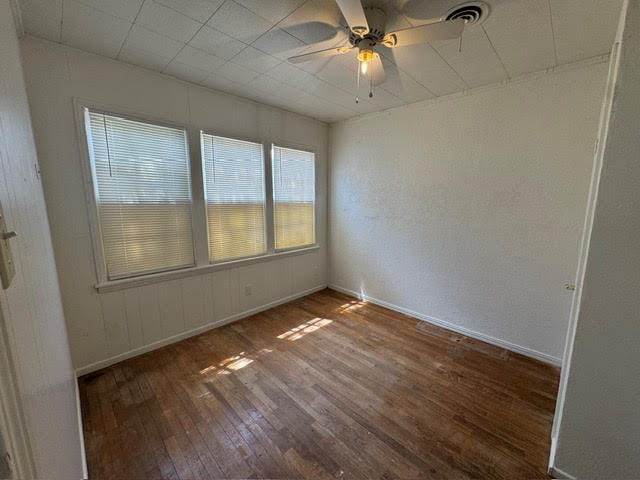 2123 25th Street Lubbock, TX 79411 - Photo 10 of 12 an empty room with wooden floor fan and windows