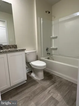 a bathroom with a toilet a sink and bathtub