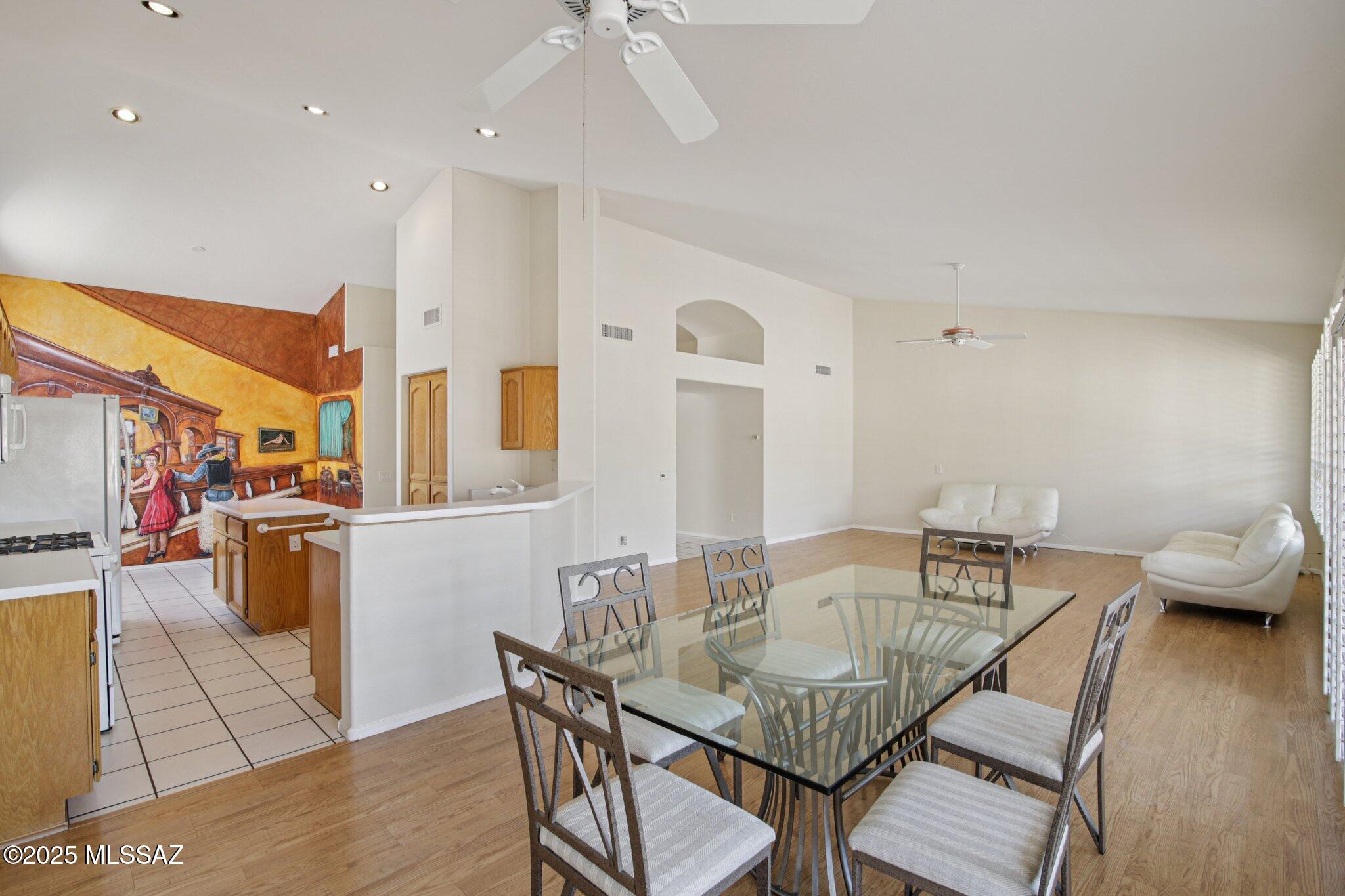 35890 Mesa Ridge Drive Tucson, AZ 85739 - Photo 9 of 31 a view of a dining room with furniture and wooden floor