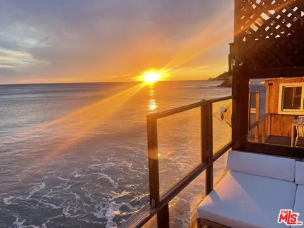 a view of a livingroom with furniture and hardwood floor