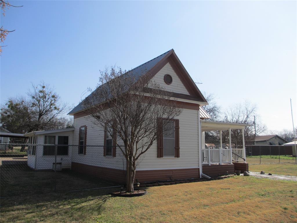 608 North Colorado Street Whitney, TX 76692 - Photo 2 of 27 a front view of a house with a yard