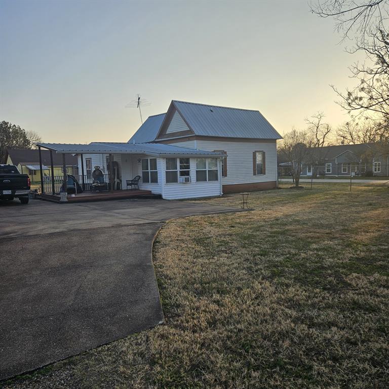 608 North Colorado Street Whitney, TX 76692 - Photo 4 of 27 a view of a big house with a big yard and large trees