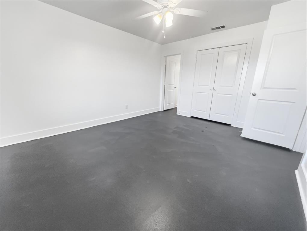 109 James Street, Unit 200 Decatur, TX 76234 - Photo 15 of 21 an empty room with a ceiling fan and bathroom view