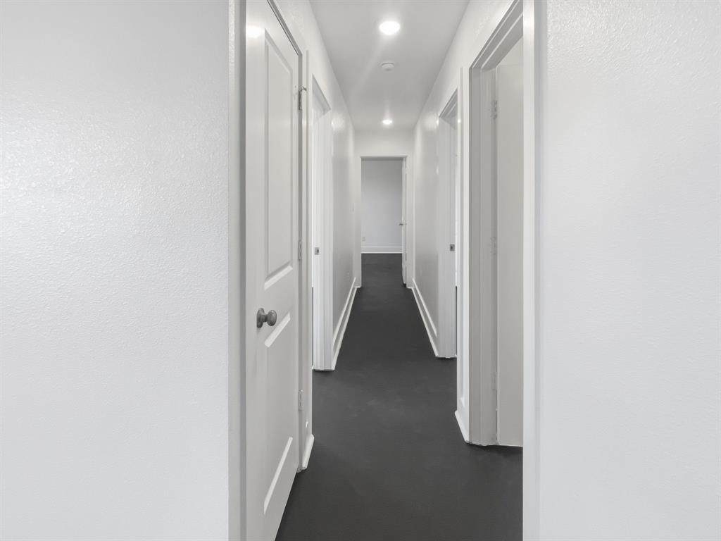 109 James Street, Unit 200 Decatur, TX 76234 - Photo 7 of 21 a view of a hallway with white walls