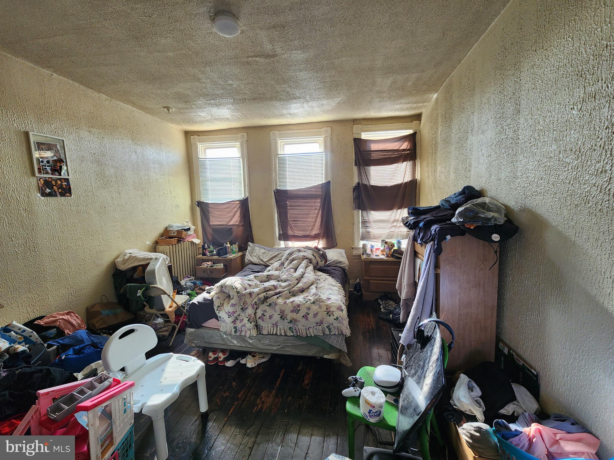 2744 Edmondson Avenue Baltimore, MD 21223 - Photo 12 of 17 a bedroom with furniture and a wooden floor