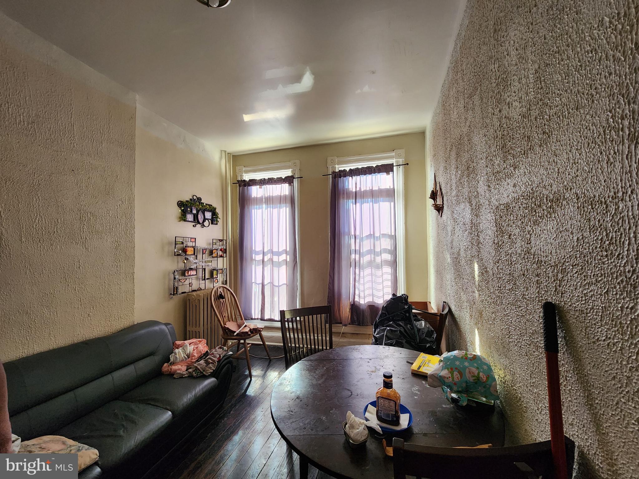 2744 Edmondson Avenue Baltimore, MD 21223 - Photo 7 of 17 a living room with furniture and a floor to ceiling window