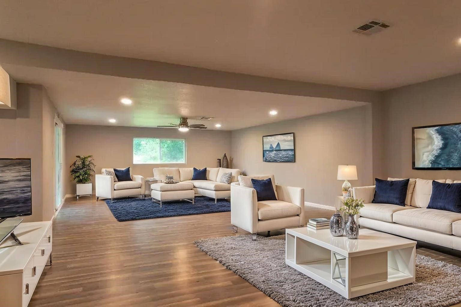25373 Goodson Road Splendora, TX 77372 - Photo 2 of 43 (Virtually Staged) Stylish room with white furniture, warm wood floors, and a cozy studio couch. Perfect for a modern living space, ideal for an upscale interior design.