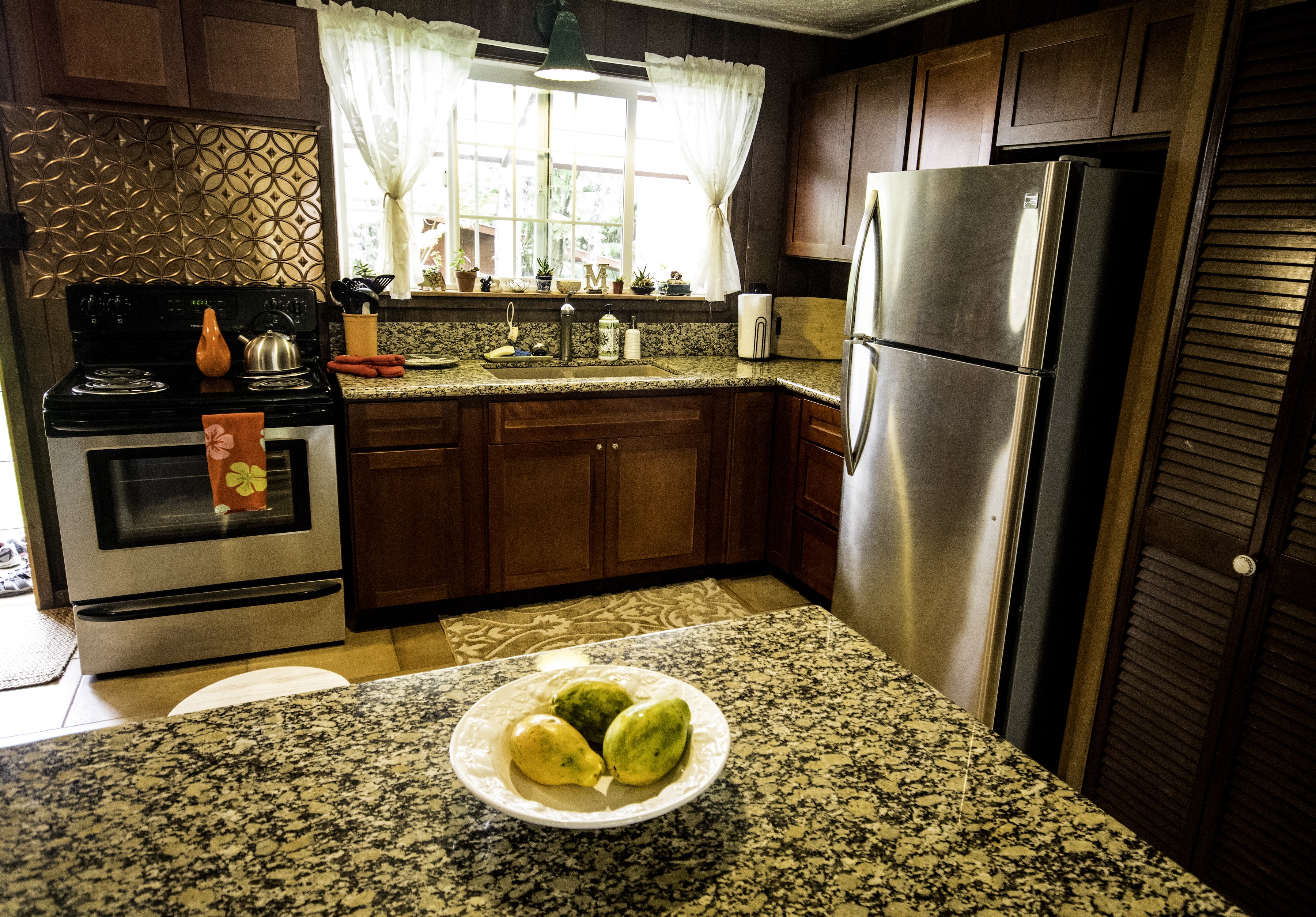11-3972 Lanihuli Road Volcano, HI 96785 - Photo 8 of 21 a kitchen with stainless steel appliances granite countertop a refrigerator and a stove