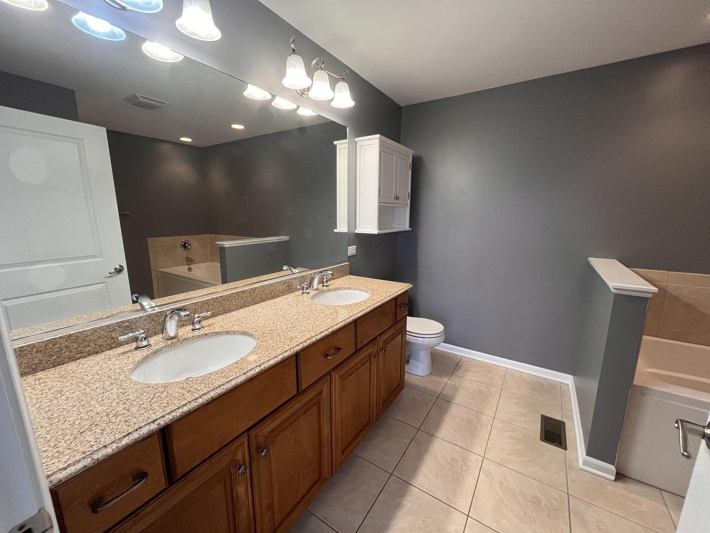 402 Chestnut Lane Beecher, IL 60401 - Photo 14 of 23 a spacious bathroom with a granite countertop sink a mirror and a toilet