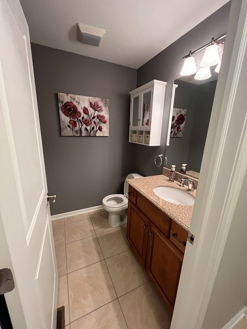 402 Chestnut Lane Beecher, IL 60401 - Photo 20 of 23 a bathroom with a granite countertop sink mirror vanity and toilet