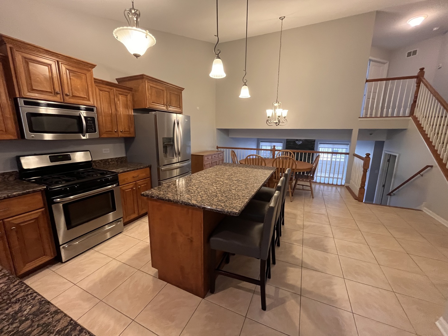 402 Chestnut Lane Beecher, IL 60401 - Photo 2 of 23 a kitchen with stainless steel appliances granite countertop a stove a sink a microwave oven a refrigerator with grey cabinets and wooden floor