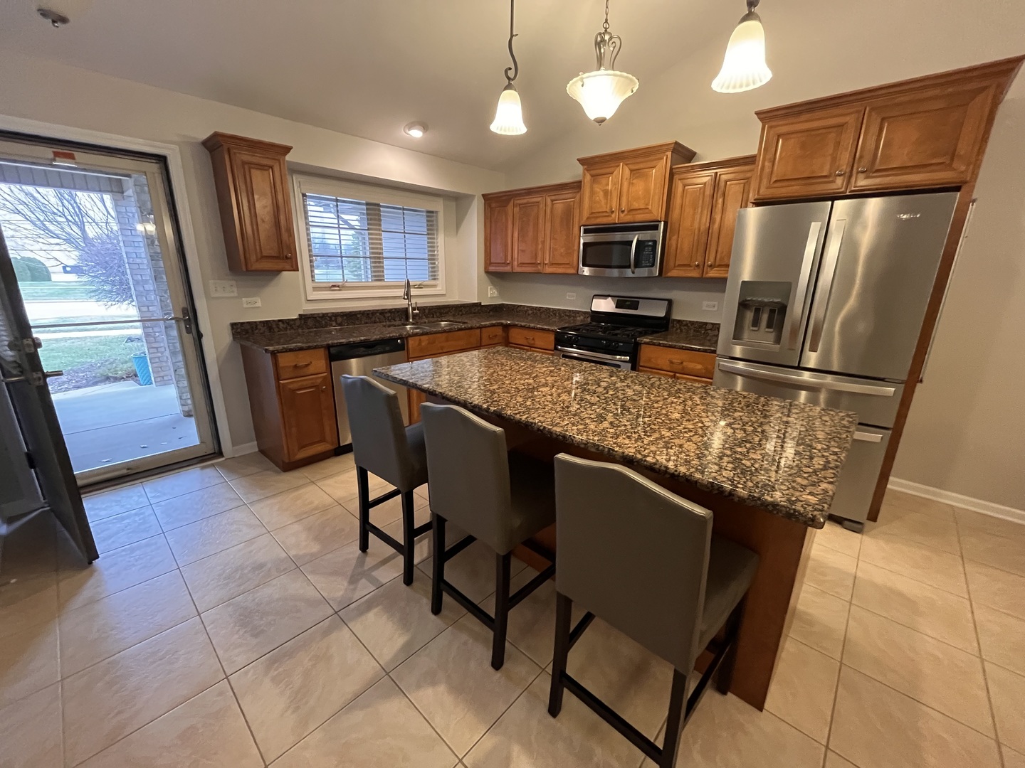 402 Chestnut Lane Beecher, IL 60401 - Photo 3 of 23 a kitchen with stainless steel appliances granite countertop a refrigerator a stove a sink a microwave and dining table