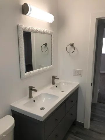 a view of a room with a hanging light and sink