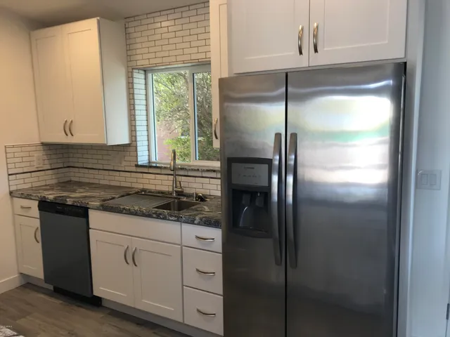 a kitchen with a refrigerator and a sink