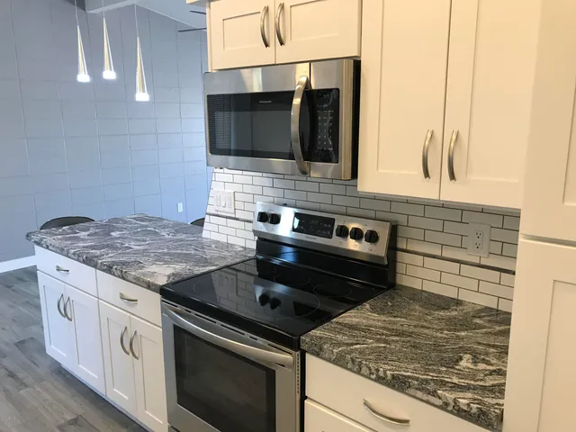 a kitchen with a stove and a microwave