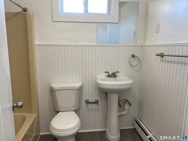 a bathroom with a sink a toilet and mirror