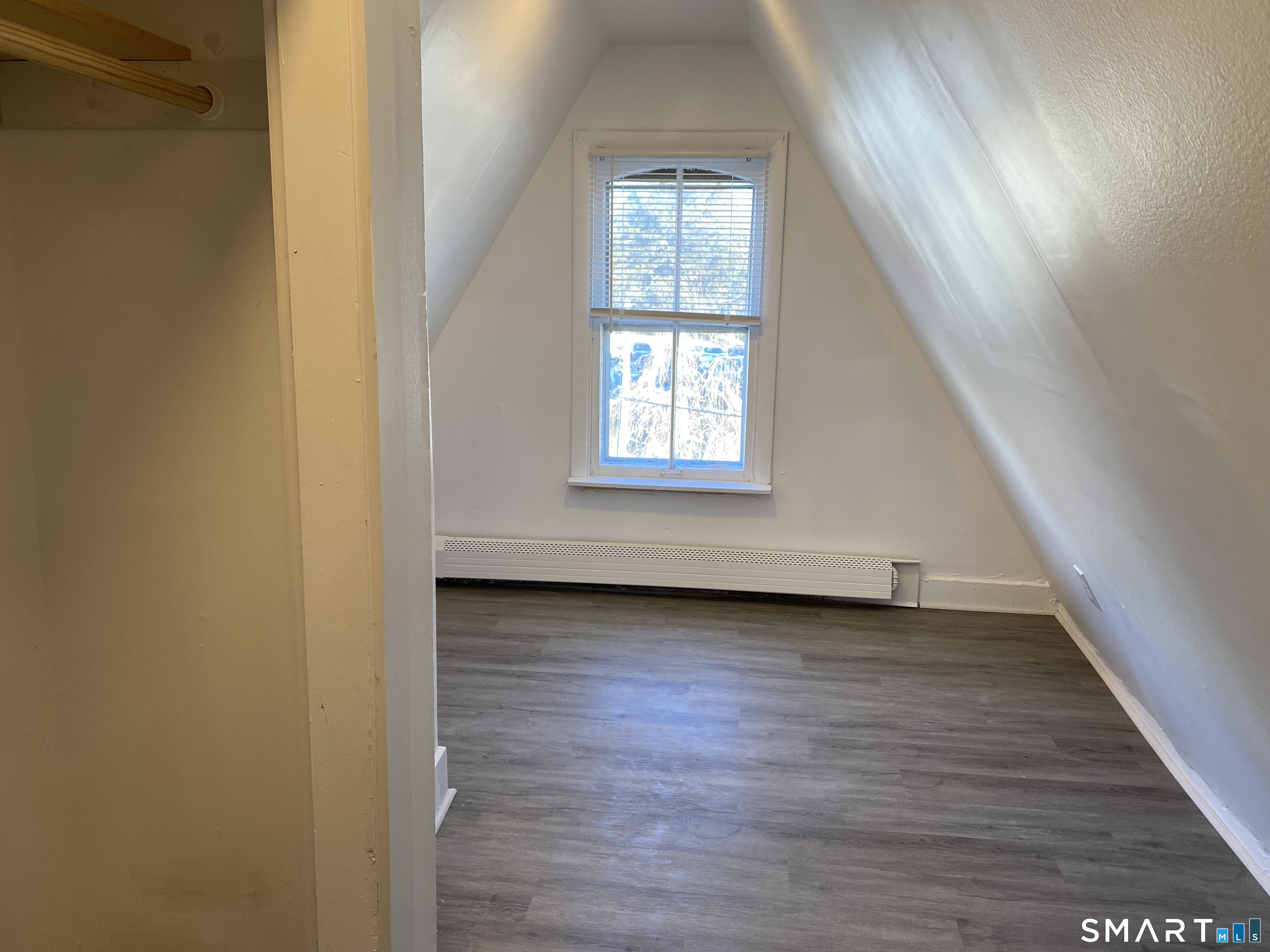 26 Prospect Street, Unit 9 New London, CT 06320 - Photo 10 of 12 an empty room with wooden floor and windows