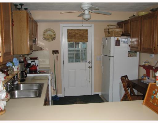 115 Ninigret Road Narragansett, RI 02882 - Photo 2 of 8 Kitchen. LOTS OF CABINETS. NEWER APPLIANCES. DOOR TO QUIET, REAR, FENCED YARD. OPEN PASS-THROUGH TO LARGE EATING AREA TOO!! START COOKING!