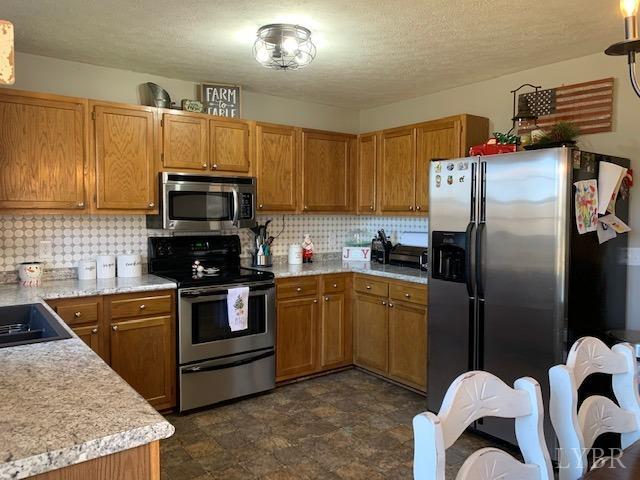 203 Kimball Road Concord, VA 24538 - Photo 5 of 27 a kitchen with stainless steel appliances granite countertop a stove a sink dishwasher a refrigerator and a microwave