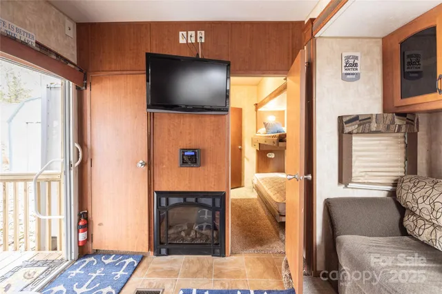 a living room with fireplace furniture and a flat screen tv