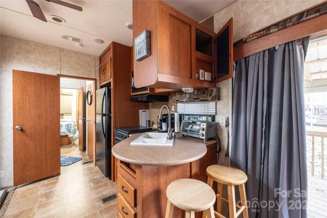 a kitchen with a sink refrigerator and dining table