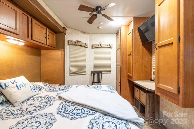 a bedroom with a bed a dresser and the shower