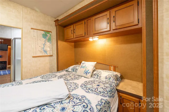 a bedroom with a bed and cabinets