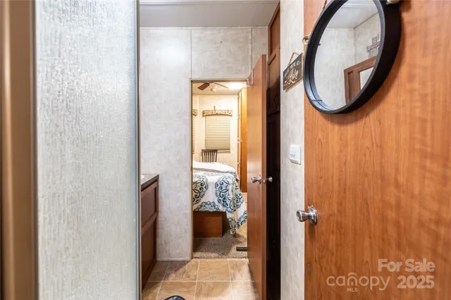 a bathroom with a toilet and a mirror