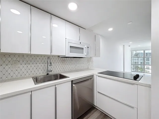 a view of a kitchen sink and cabinets