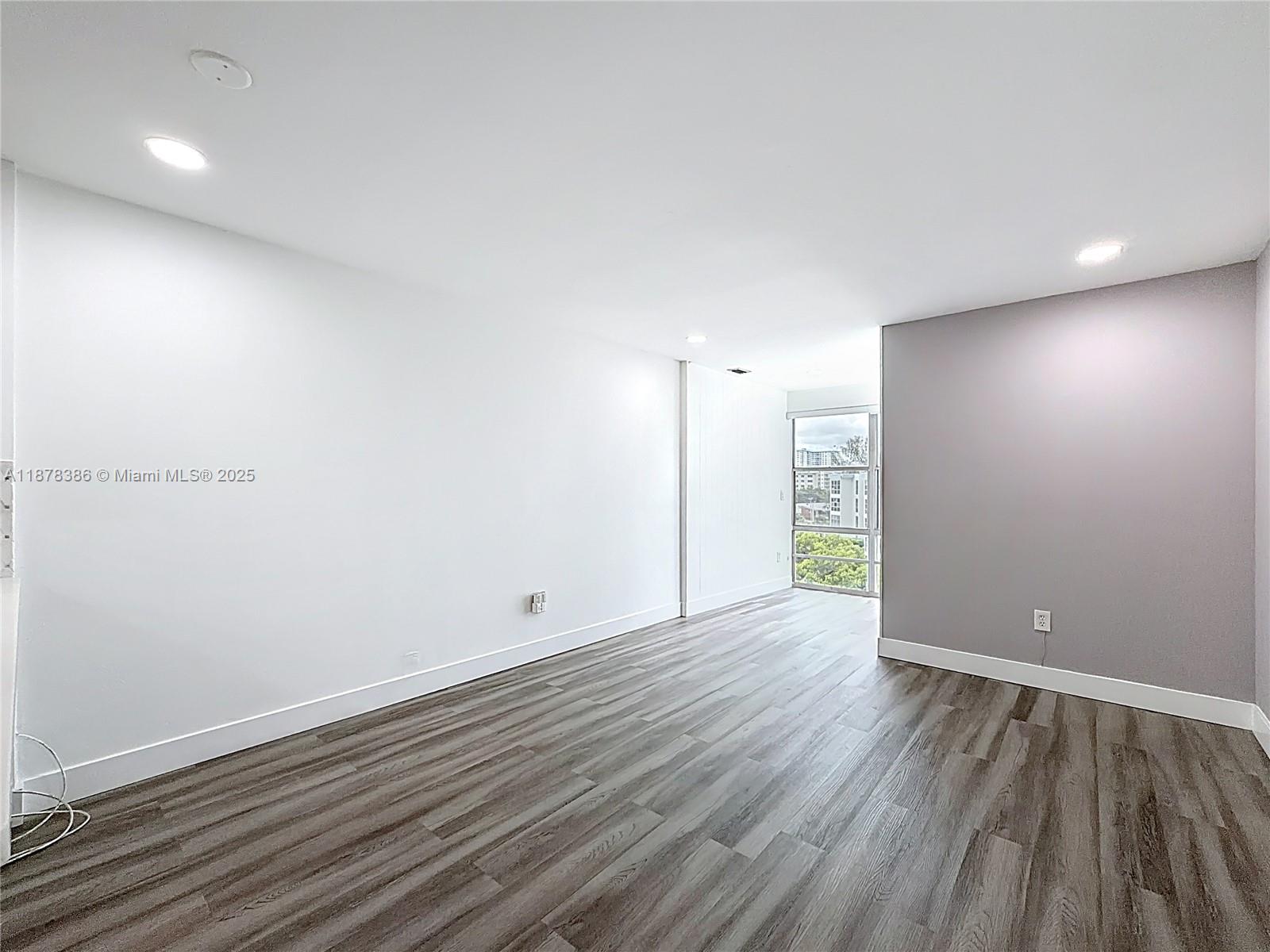 17620 Atlantic Boulevard, Unit 505 Sunny Isles Beach, FL 33160 - Photo 19 of 35 an empty room with wooden floor and windows