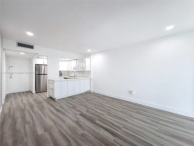 a view of a kitchen with wooden floor and a sink