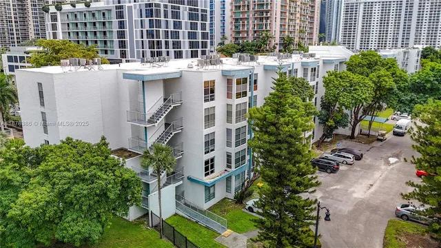 a view of a buildings with yard and sitting area