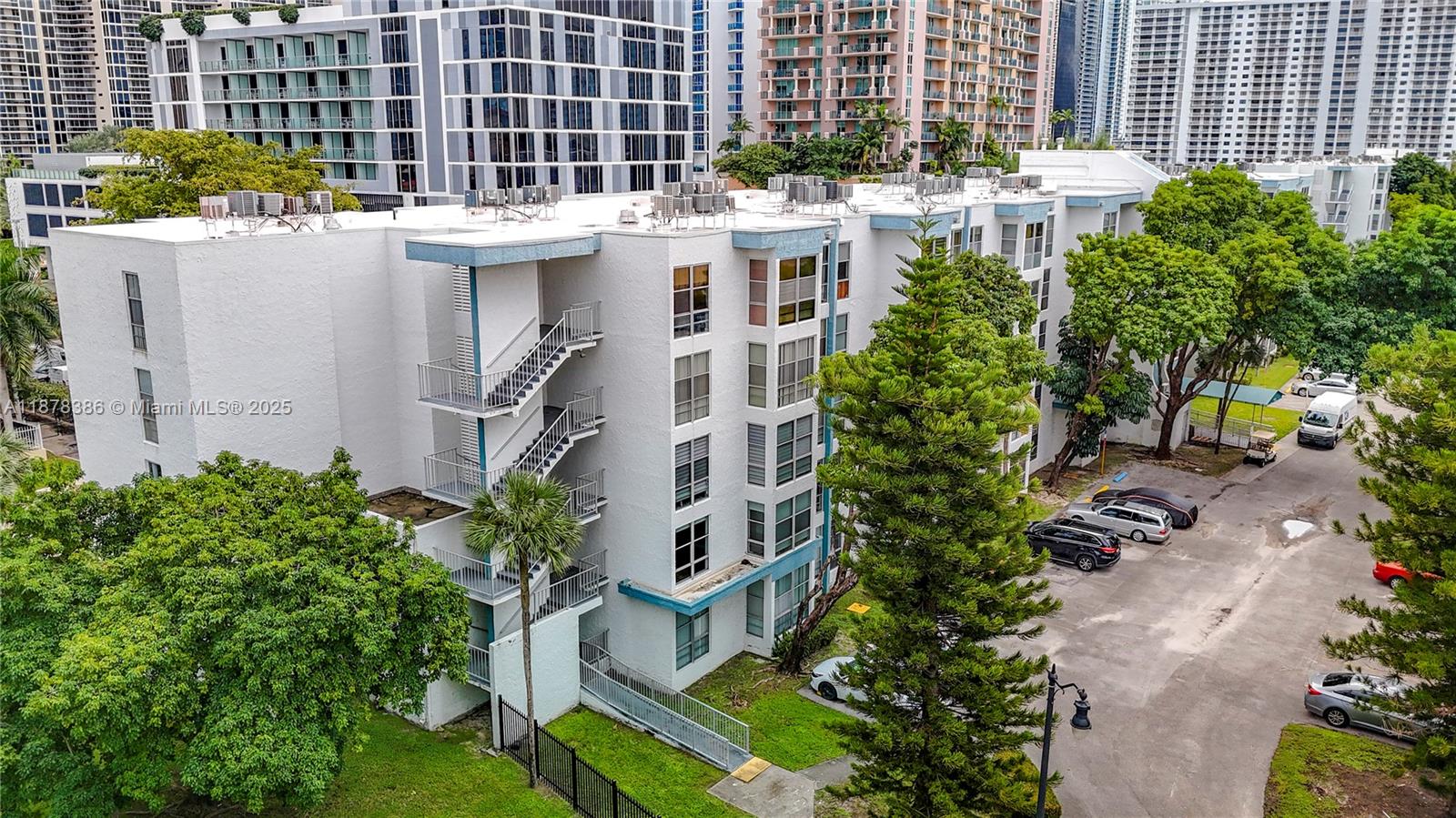 17620 Atlantic Boulevard, Unit 505 Sunny Isles Beach, FL 33160 - Photo 2 of 35 a view of a buildings with yard and sitting area