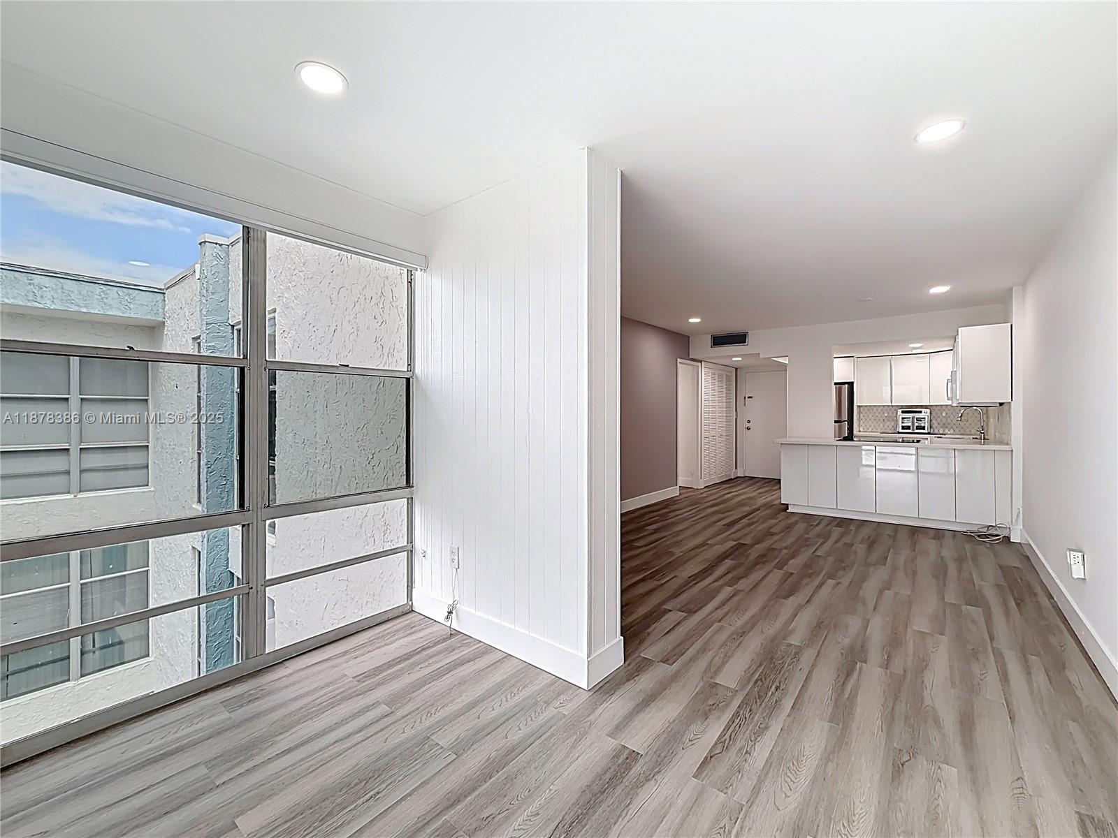17620 Atlantic Boulevard, Unit 505 Sunny Isles Beach, FL 33160 - Photo 21 of 35 a view of a kitchen with wooden floor and a sink