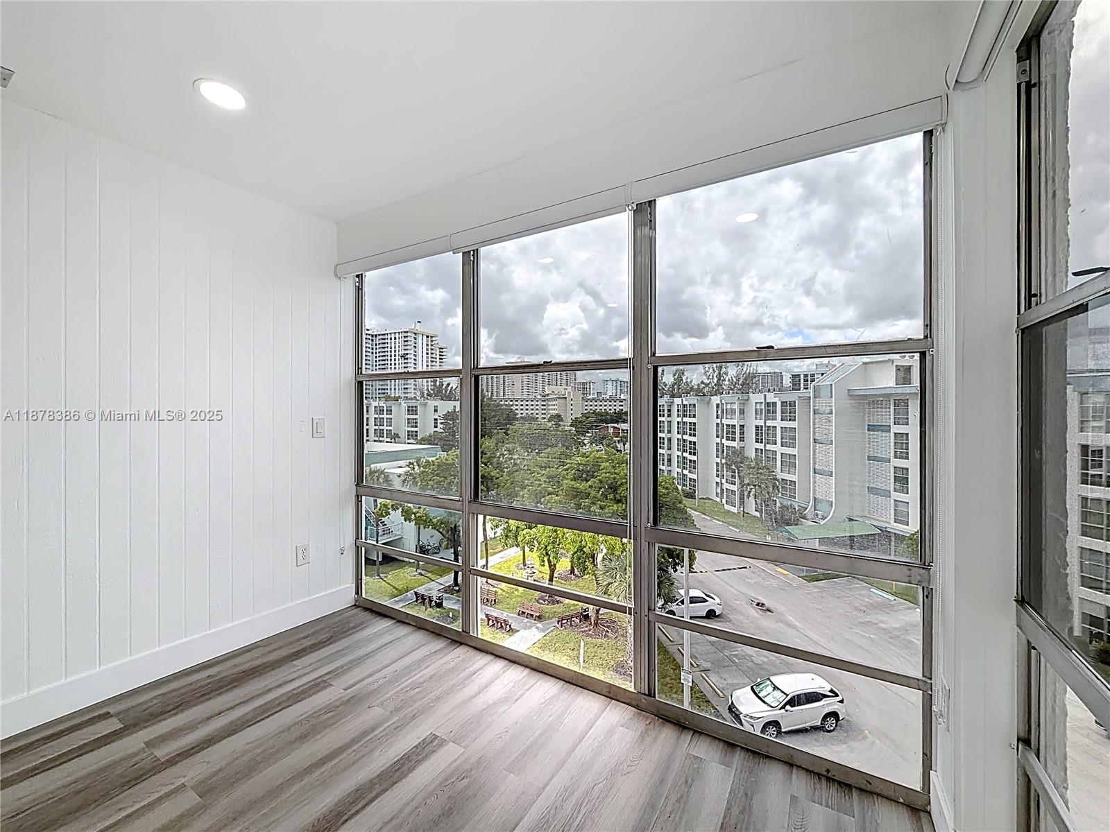 17620 Atlantic Boulevard, Unit 505 Sunny Isles Beach, FL 33160 - Photo 25 of 35 wooden floor in an empty room with a window