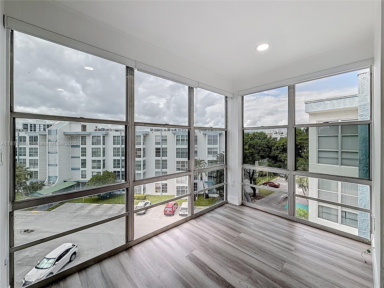 17620 Atlantic Boulevard, Unit 505 Sunny Isles Beach, FL 33160 - Photo 27 of 35 a view of a large room with wooden floor and windows
