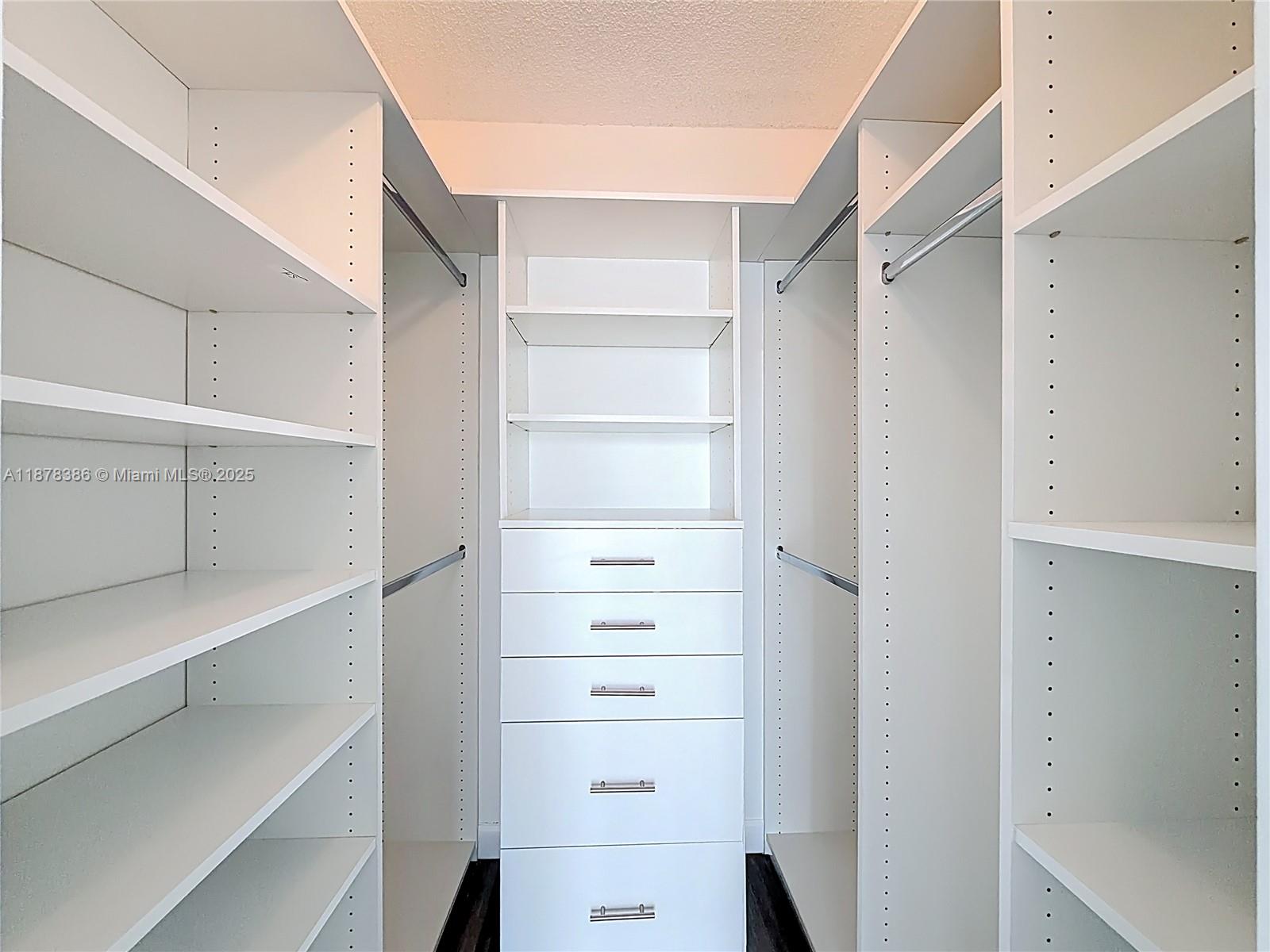 17620 Atlantic Boulevard, Unit 505 Sunny Isles Beach, FL 33160 - Photo 29 of 35 a view of walk in closet with empty racks