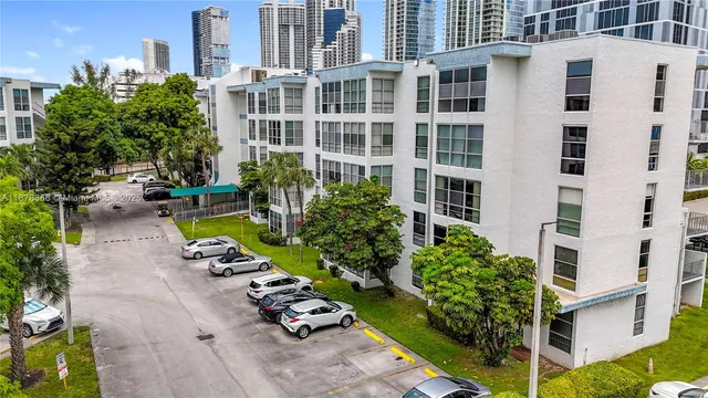 a view of a swimming pool with a lounge chairs in front of a building
