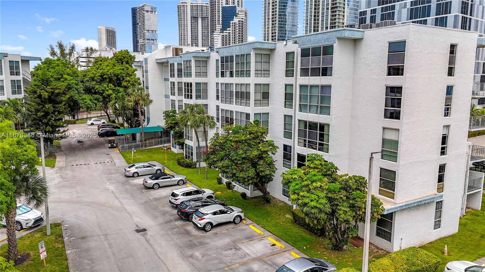 17620 Atlantic Boulevard, Unit 505 Sunny Isles Beach, FL 33160 - Photo 4 of 35 a view of a swimming pool with a lounge chairs in front of a building