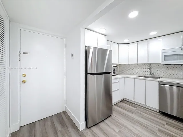 a kitchen with a refrigerator and a sink
