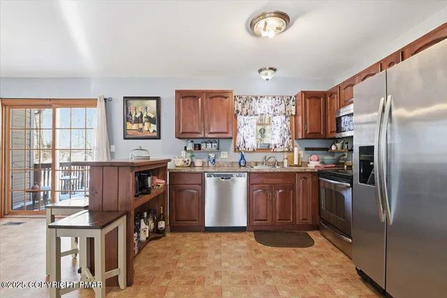 a view of a livingroom with a window and a ceiling fan