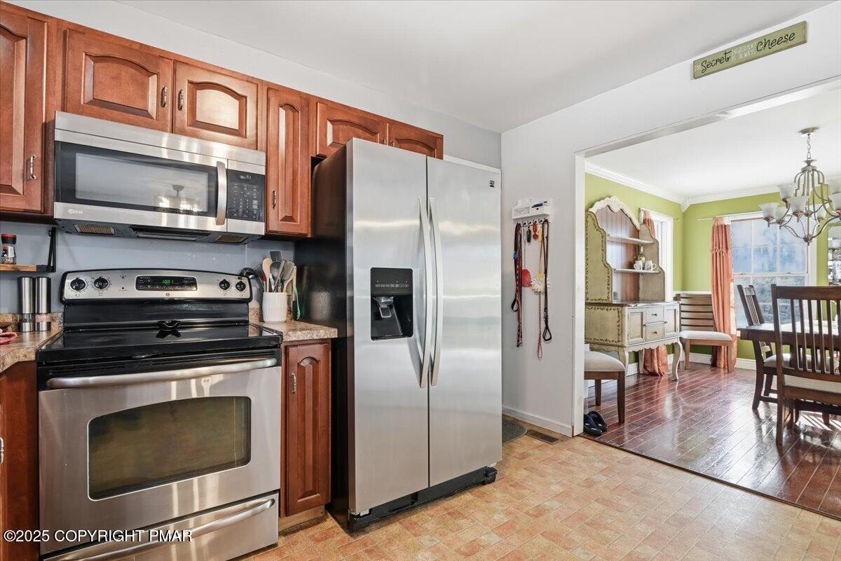 106 Ashley Court Bushkill, PA 18324 - Photo 14 of 61 a kitchen with stainless steel appliances a stove a refrigerator and a fireplace